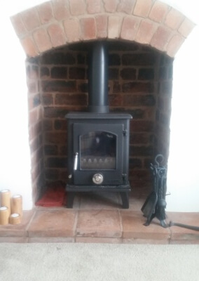 A clean burn multi fuel stove with a quarry tiled hearth and existing arch - Sedgley, Wolverhampton