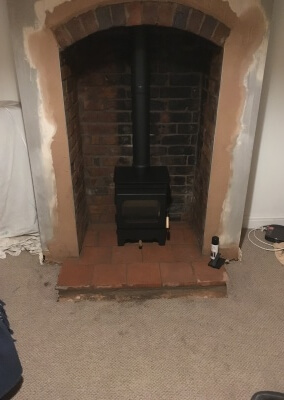 Burley Woodburning Stove With A Quarry Tiled Hearth & Original Arch.